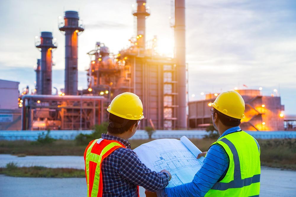 Supervision — engineers reviewing plans on-site